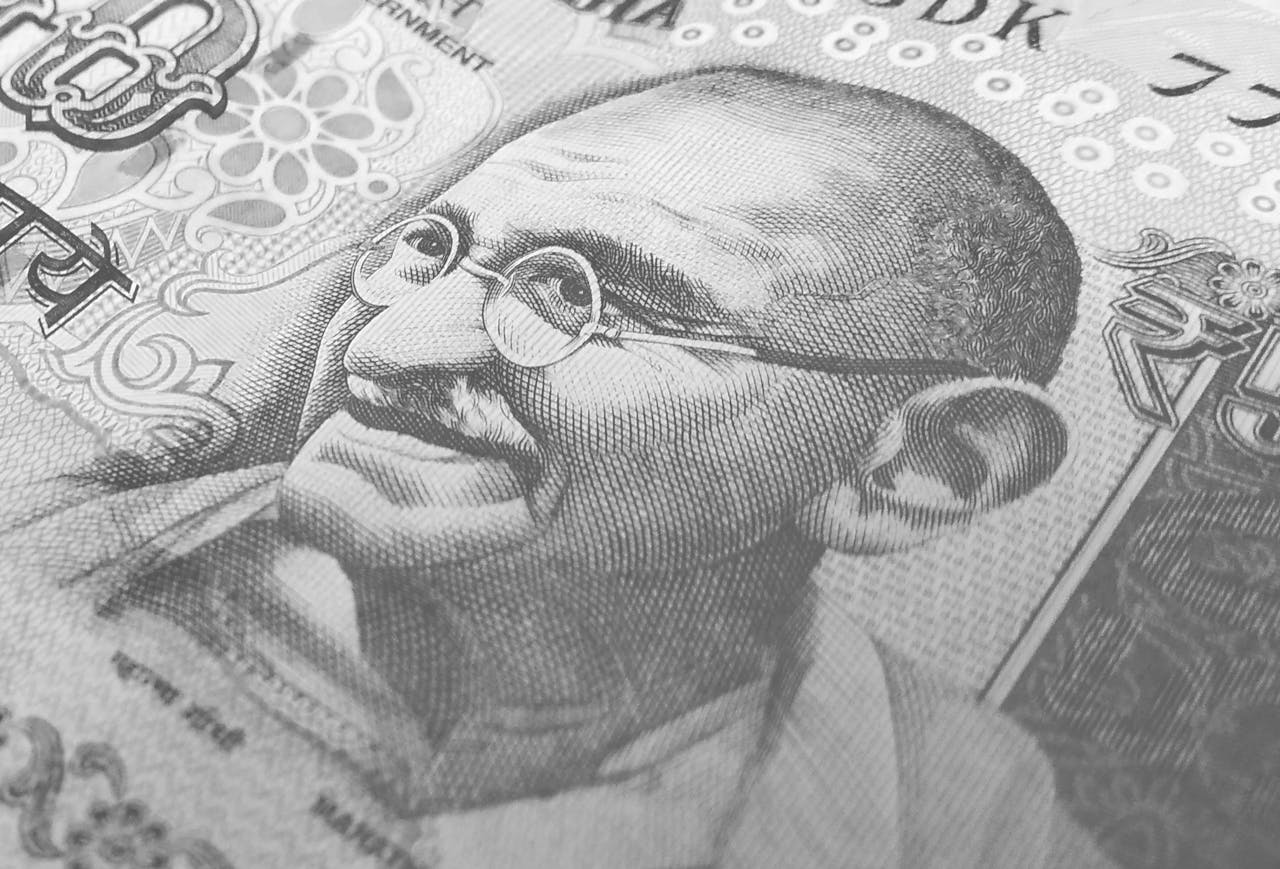 gallery-1 Detailed monochrome depiction of an Indian rupee banknote with Gandhi's portrait, symbolizing finance and economy.